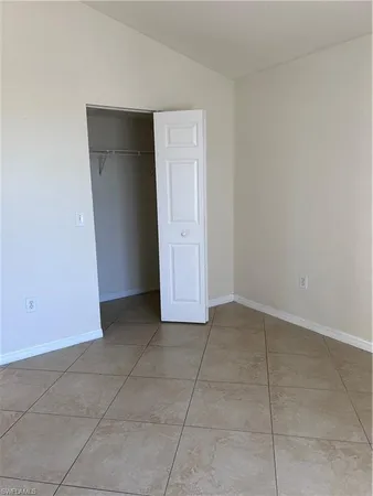 a view of an empty room with closet
