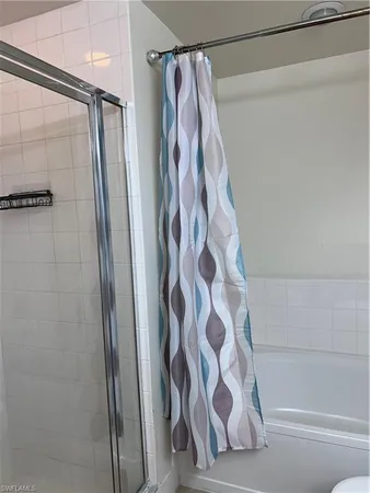 a bathroom with a shower and a shower curtain