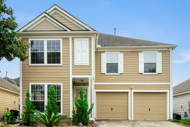 a view of a house with a yard and front door