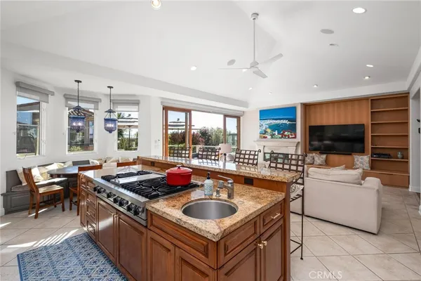 a large kitchen with granite countertop a sink and cabinets