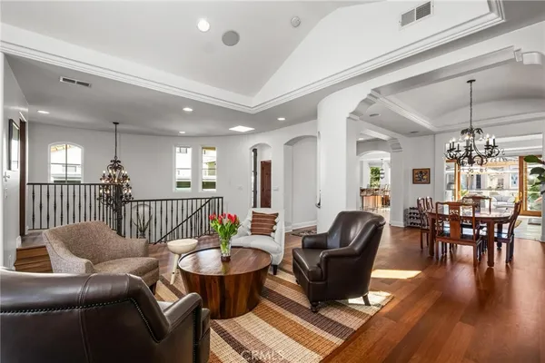 a dining room with furniture potted plants and wooden floor