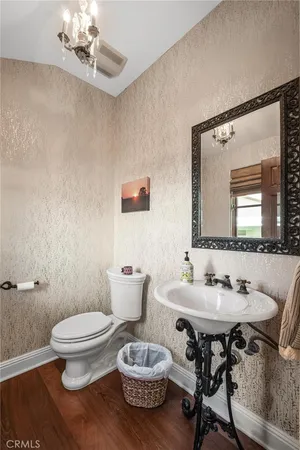 a bathroom with a sink toilet and mirror