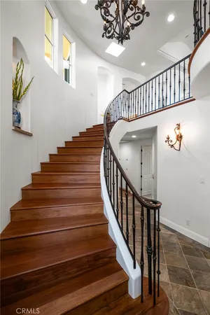 a bedroom with a bed and a flat tv screen on dresser