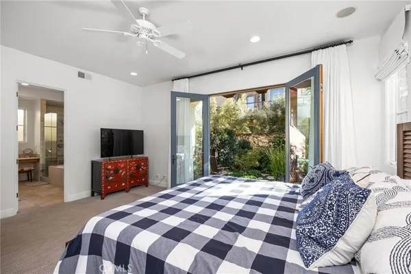 a spacious bedroom with a bed and a window