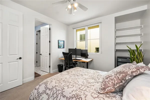 a bedroom with a bed and a desk