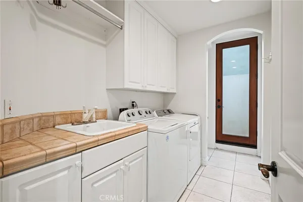 a view of a patio with plants and chairs
