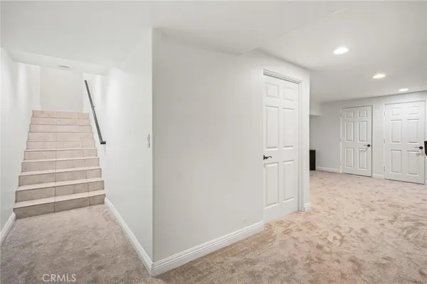 a patio with couches and a potted plant