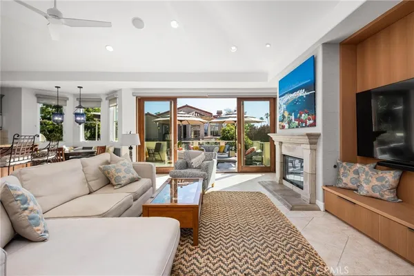 a living room with furniture kitchen view and large windows