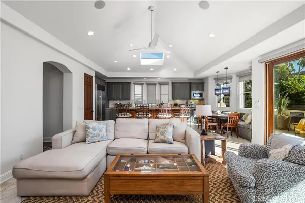 a living room with lots of furniture and view of kitchen