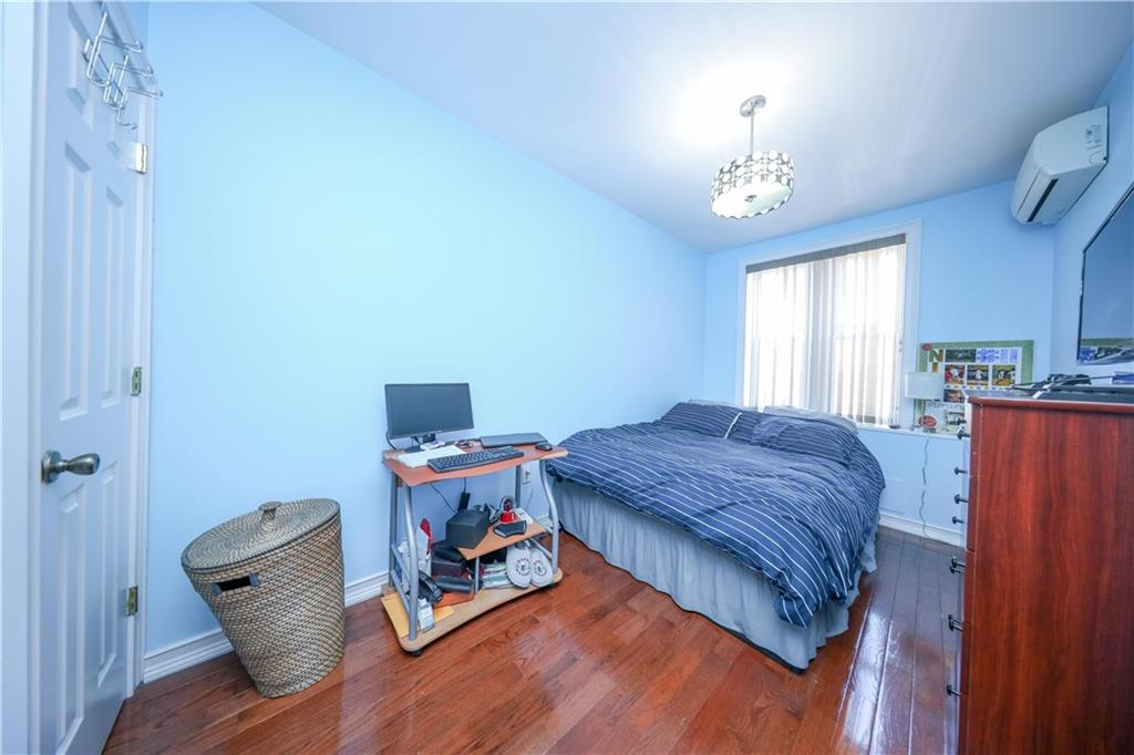 196 Quentin Road Brooklyn, NY 11223 - Photo 14 of 29 a bedroom with furniture and a chandelier