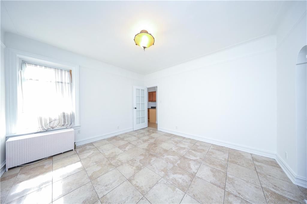 196 Quentin Road Brooklyn, NY 11223 - Photo 19 of 29 a view of an empty room with a window