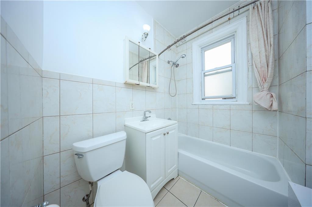 196 Quentin Road Brooklyn, NY 11223 - Photo 22 of 29 a bathroom with a toilet sink and bathtub
