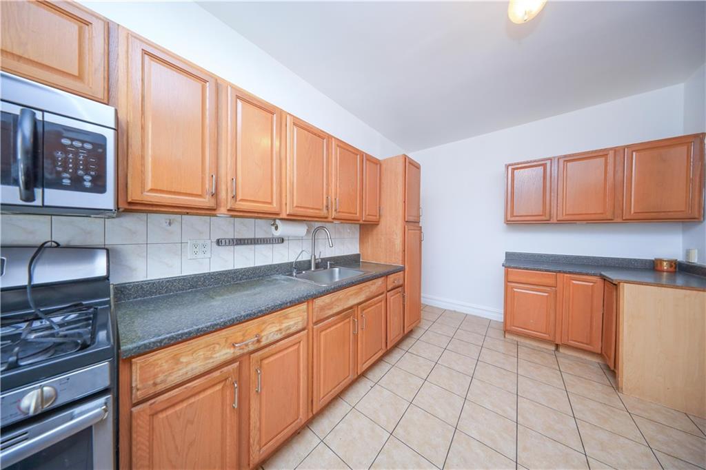 196 Quentin Road Brooklyn, NY 11223 - Photo 8 of 29 a kitchen with stainless steel appliances granite countertop a sink stove and cabinets
