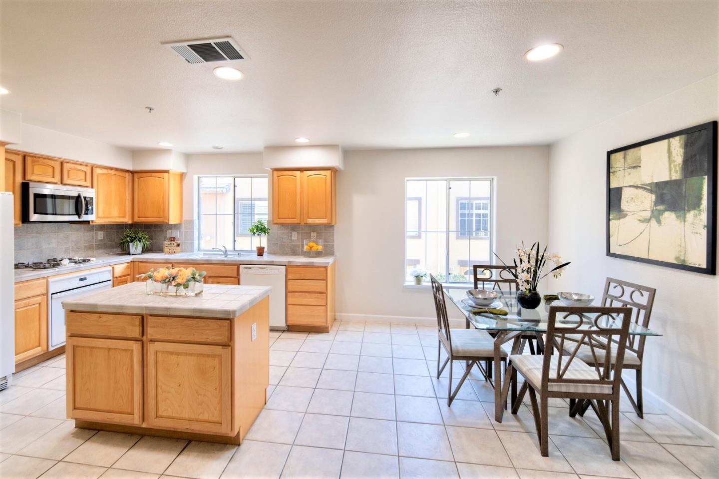 3111 White Riesling Place San Jose, CA 95135 - Photo 7 of 24 a kitchen with a stove a sink a dining table and chairs