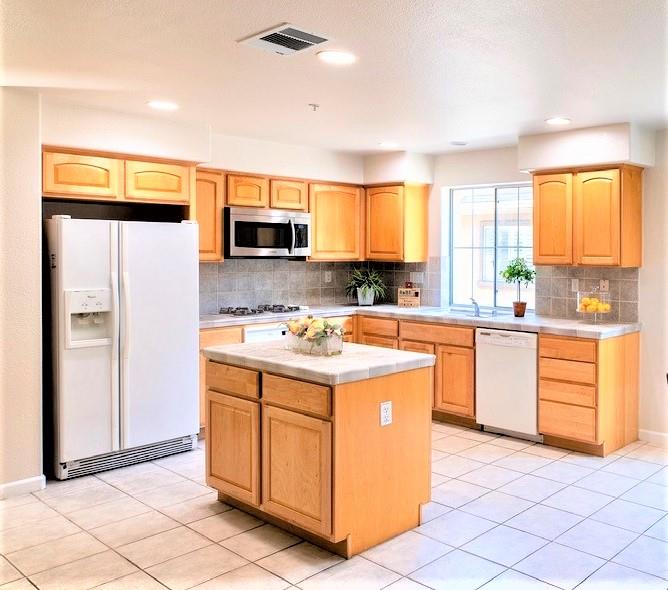3111 White Riesling Place San Jose, CA 95135 - Photo 8 of 24 a kitchen with a stove a sink and a refrigerator
