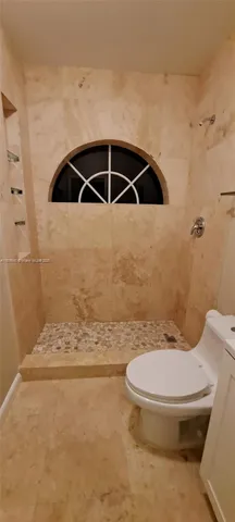 a bathroom with a sink mirror vanity and toilet