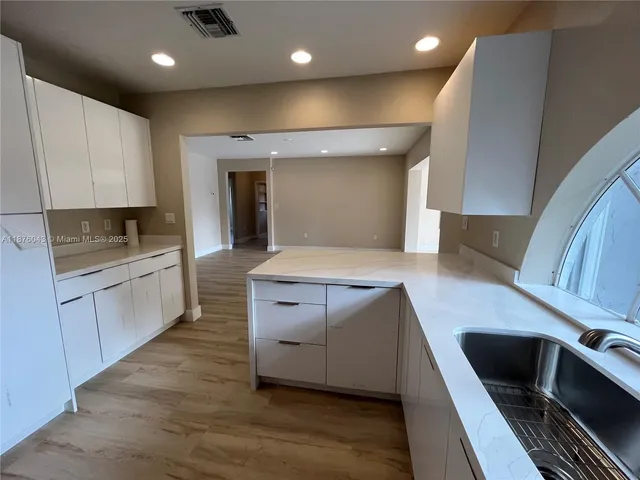 a kitchen with a sink and cabinets