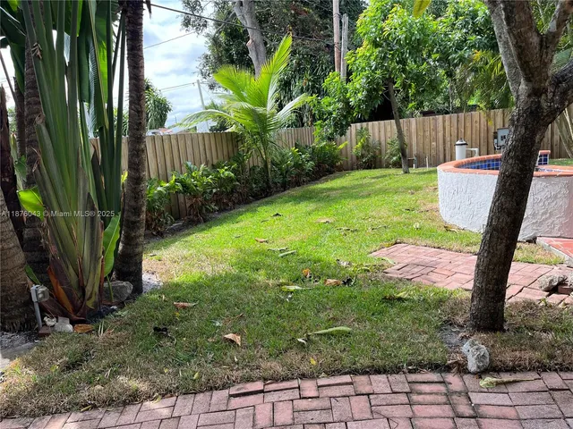 a view of yard with green space and seating area