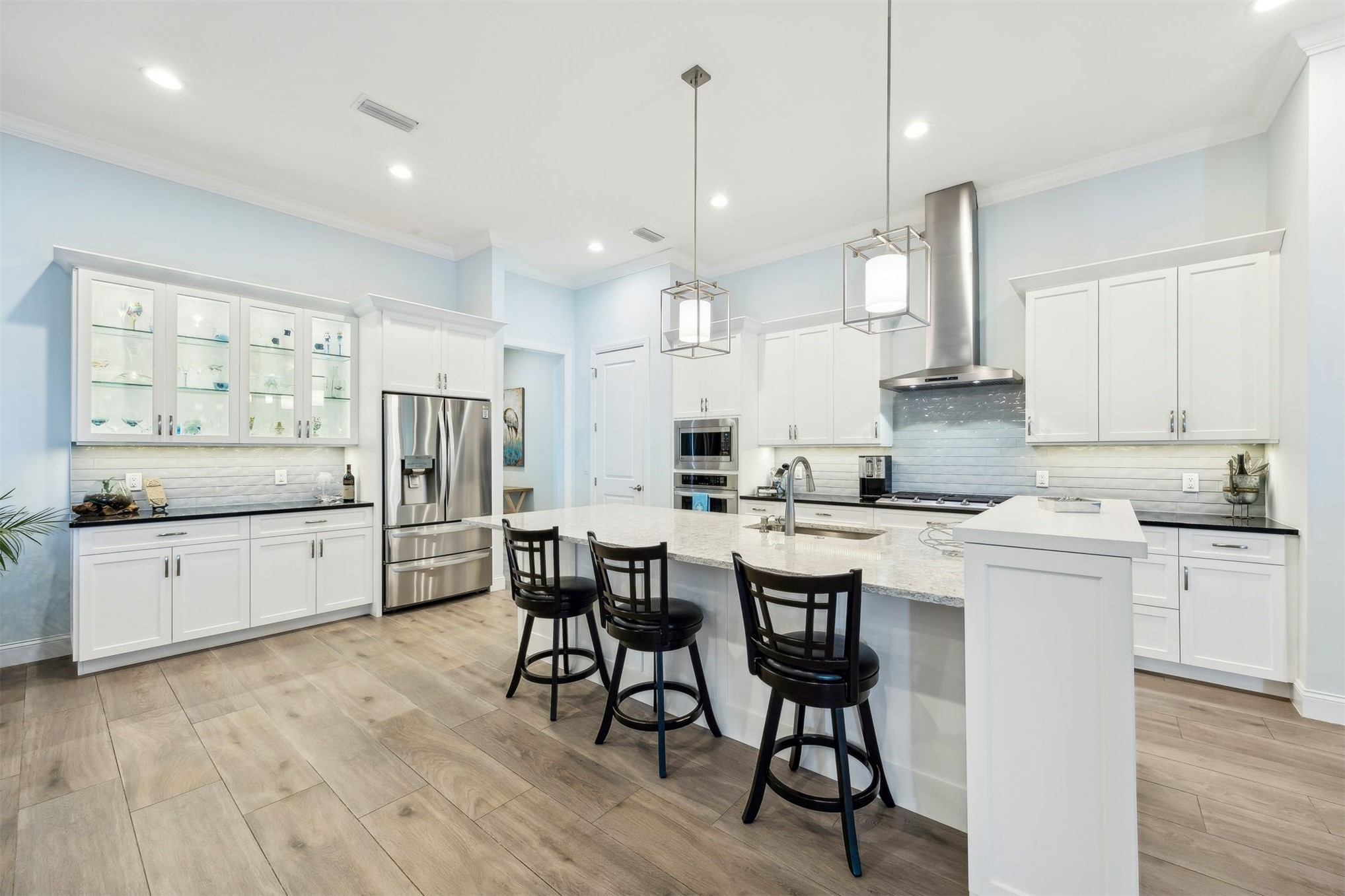 96029 Brady Point Road Fernandina Beach, FL 32034 - Photo 16 of 61 a kitchen with stainless steel appliances kitchen island granite countertop a table chairs sink and cabinets