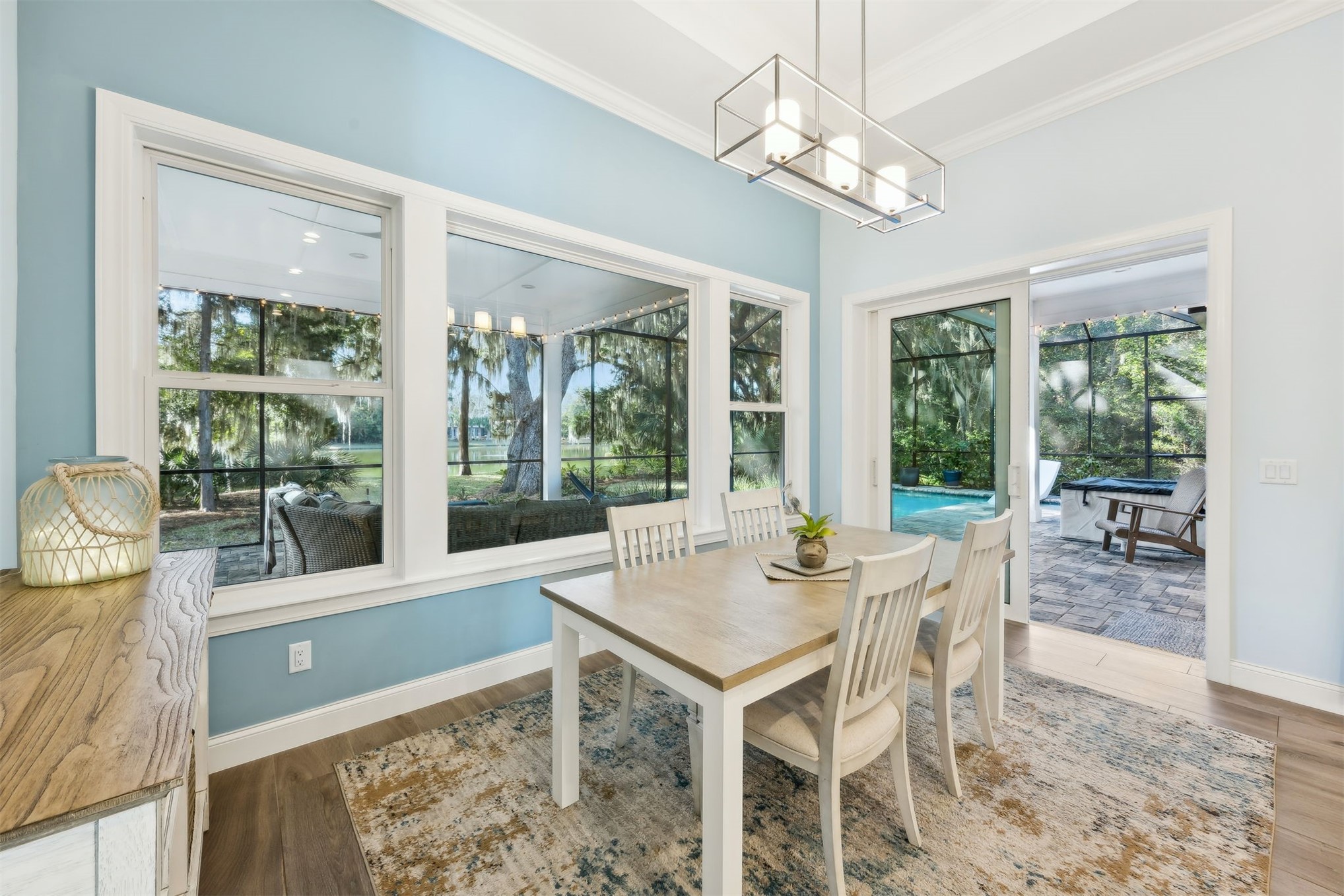 96029 Brady Point Road Fernandina Beach, FL 32034 - Photo 18 of 61 a dining room with wooden floor and a chandelier