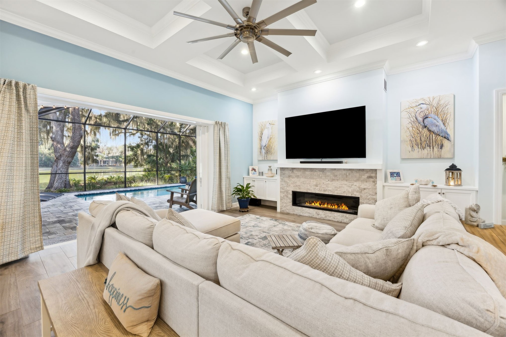 96029 Brady Point Road Fernandina Beach, FL 32034 - Photo 2 of 61 a living room with furniture a fireplace and a flat screen tv