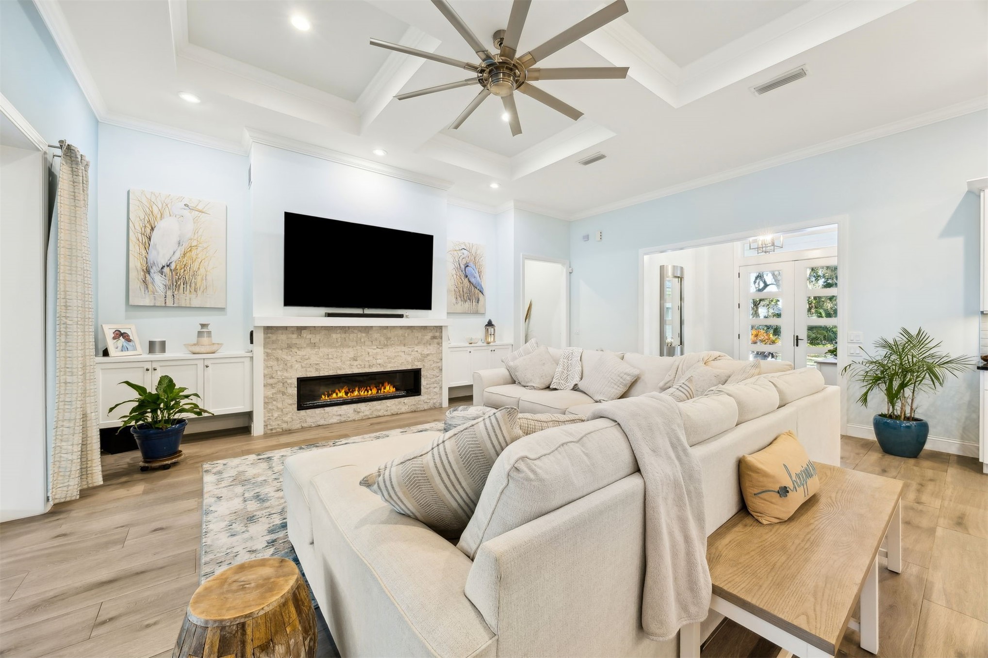 96029 Brady Point Road Fernandina Beach, FL 32034 - Photo 7 of 61 a living room with furniture a fireplace and a flat screen tv