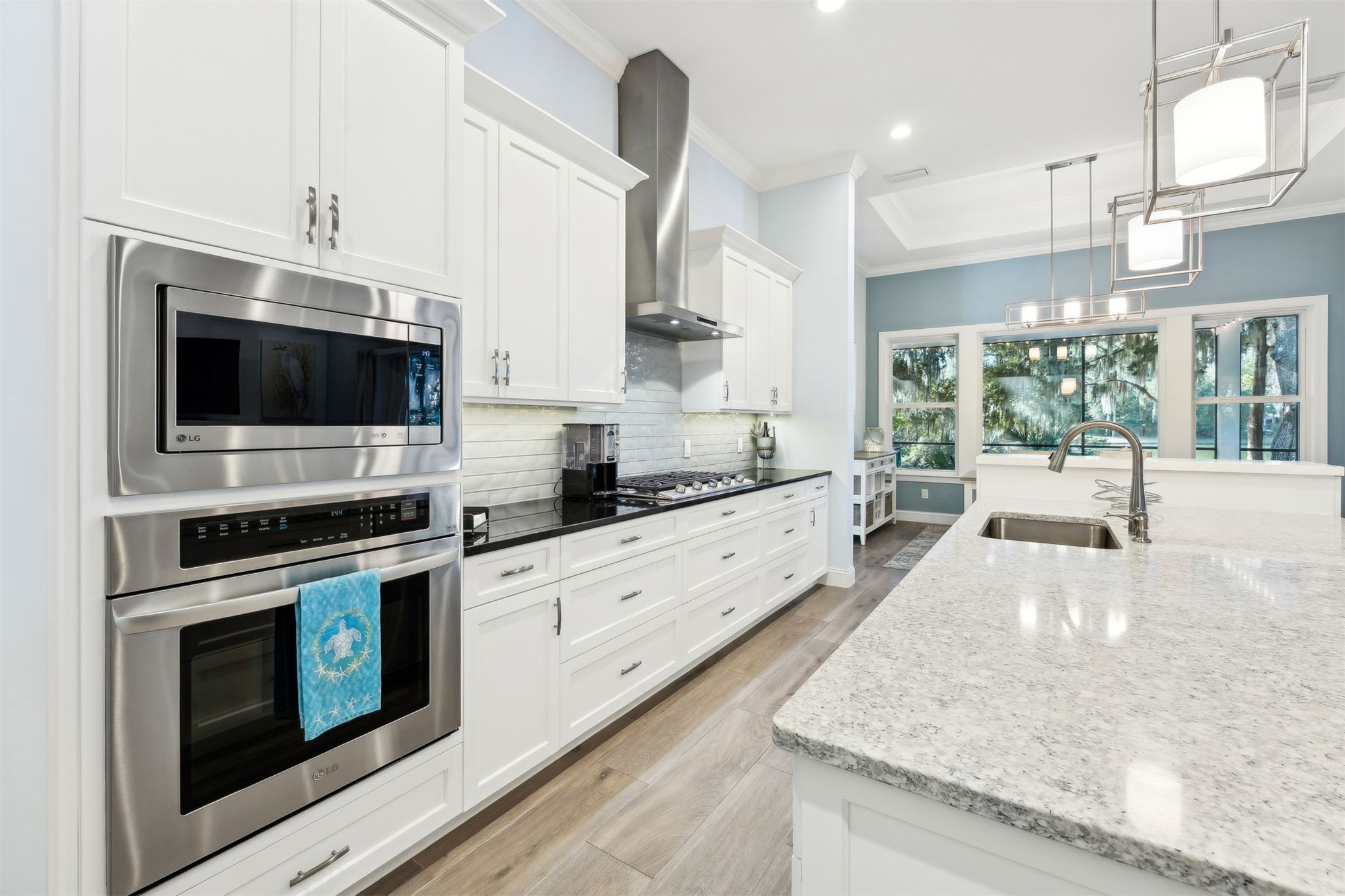 96029 Brady Point Road Fernandina Beach, FL 32034 - Photo 10 of 61 a large kitchen with stainless steel appliances granite countertop a stove a sink and a microwave