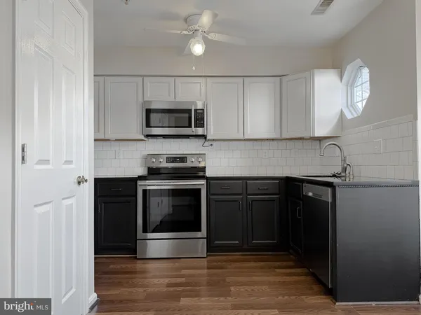 a kitchen with a stove and a microwave