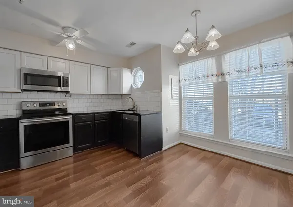 a kitchen with granite countertop stainless steel appliances and wooden cabinets