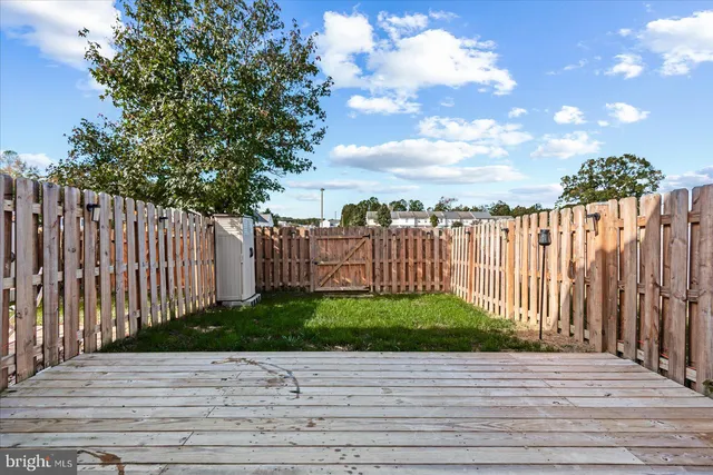 a view of a backyard with wooden fence
