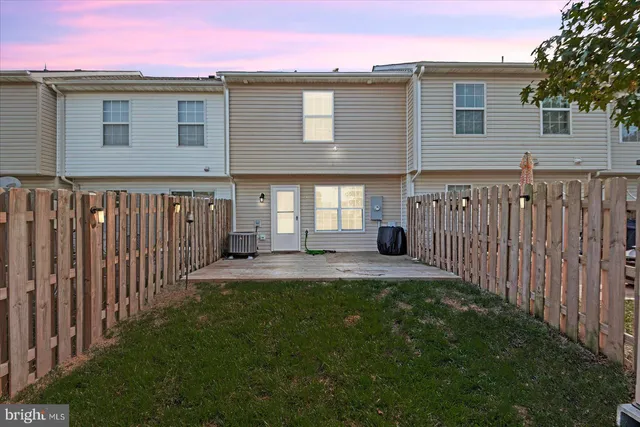 a front view of a house with yard and deck