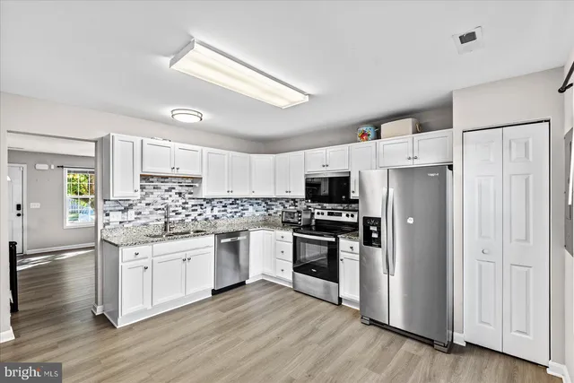 a kitchen with stainless steel appliances and wooden cabinets