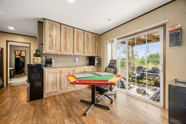 a kitchen with a table chairs and a refrigerator