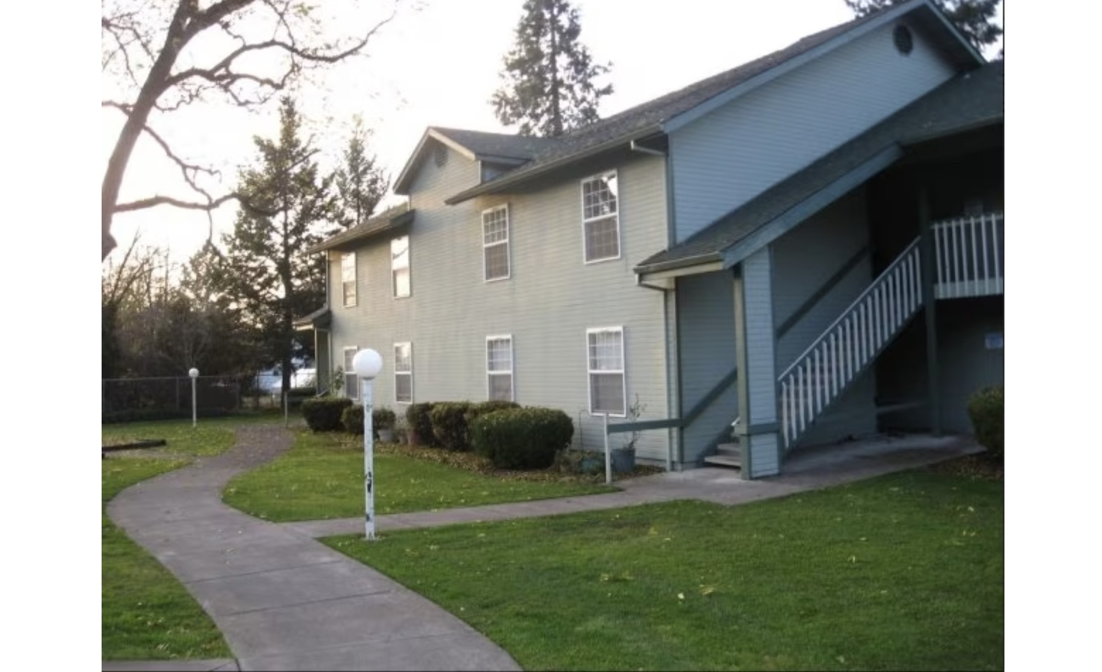 113 Onyx Street Eagle Point, OR 97524 - Photo 6 of 6 a view of a white house with a yard and plants