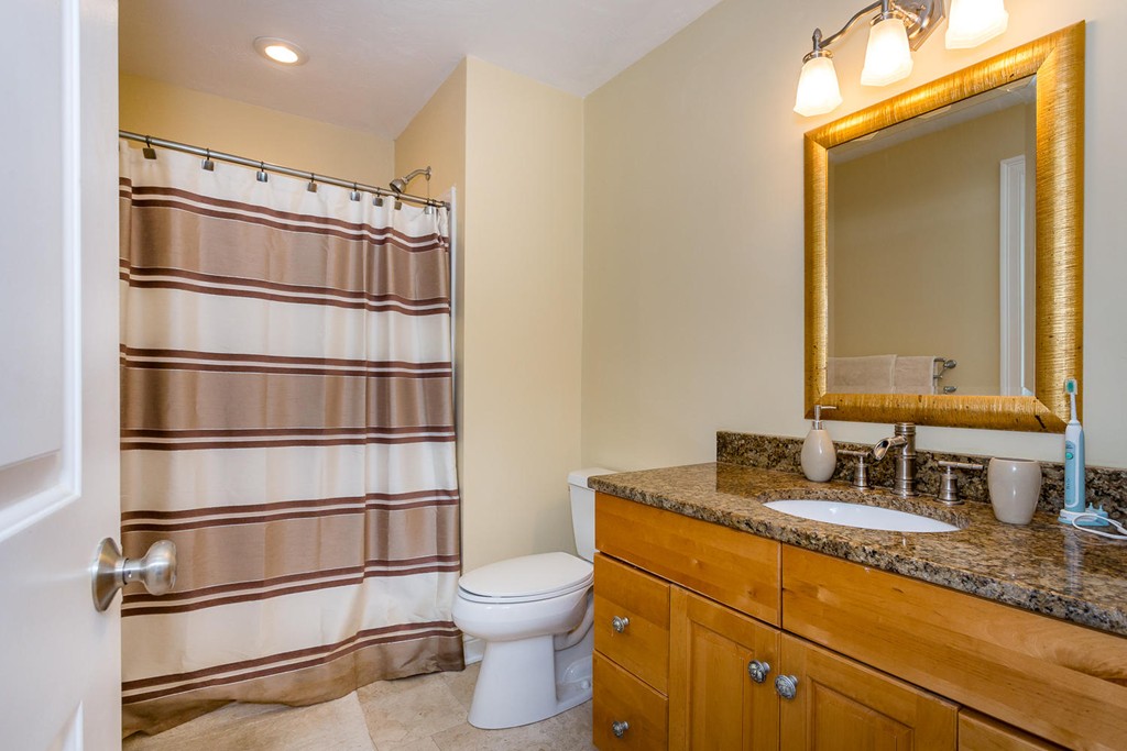 17 Endicott Street, Unit 17 Canton, MA 02021 - Photo 12 of 18 a bathroom with a granite countertop sink vanity mirror and toilet