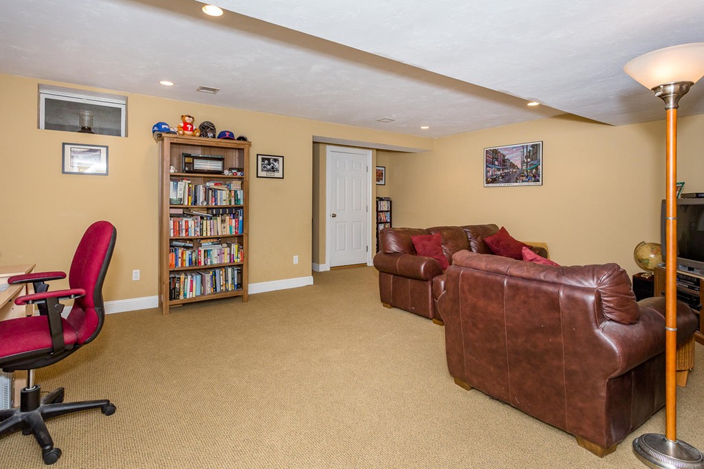 17 Endicott Street, Unit 17 Canton, MA 02021 - Photo 13 of 18 a living room with furniture a couch and a bookshelf