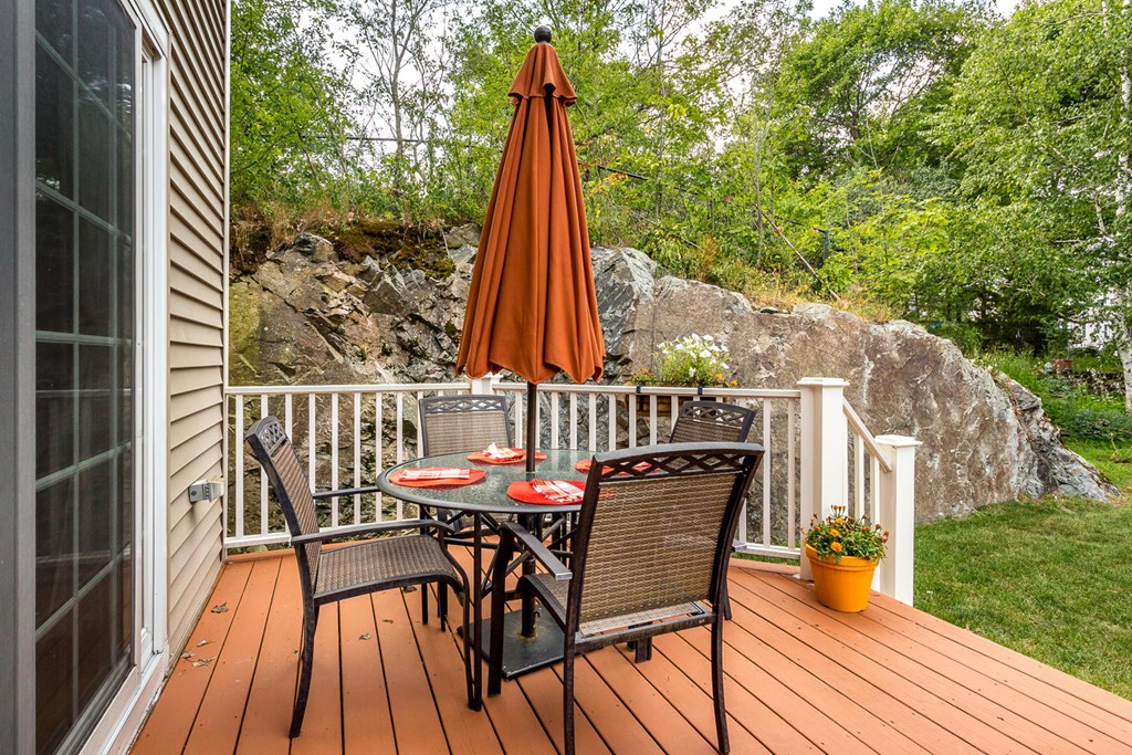 17 Endicott Street, Unit 17 Canton, MA 02021 - Photo 16 of 18 a view of deck with a table and chairs a barbeque with wooden floor and fence