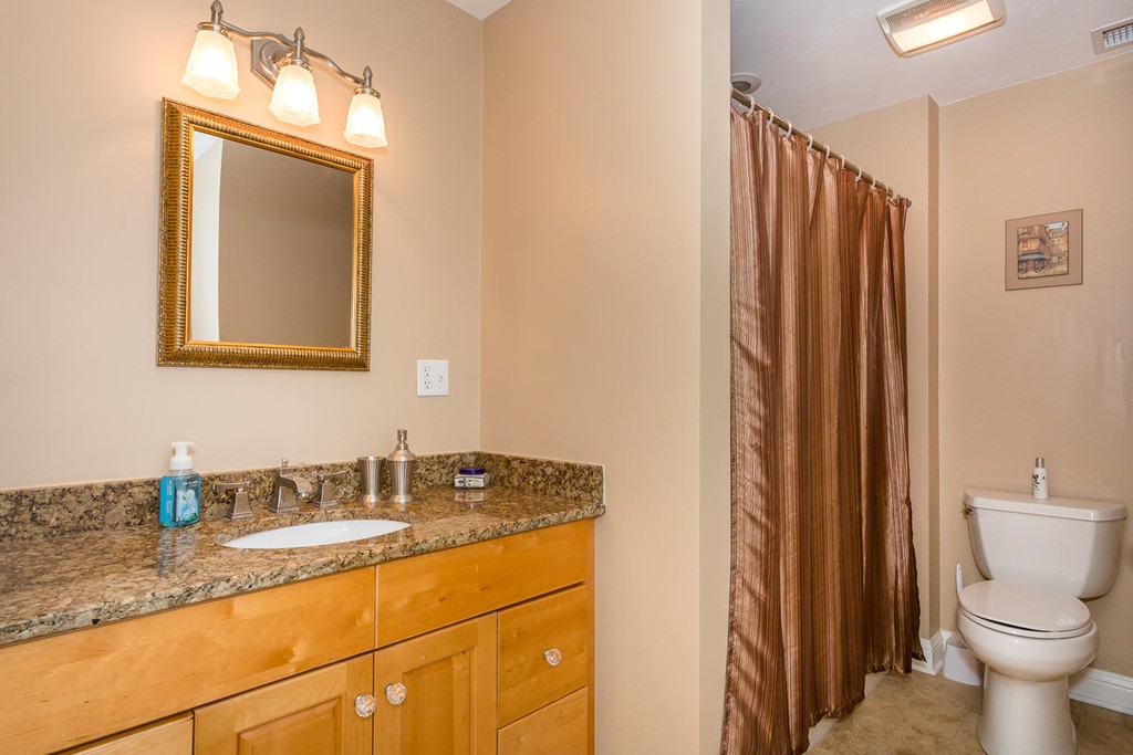 17 Endicott Street, Unit 17 Canton, MA 02021 - Photo 9 of 18 a bathroom with a granite countertop sink and a mirror