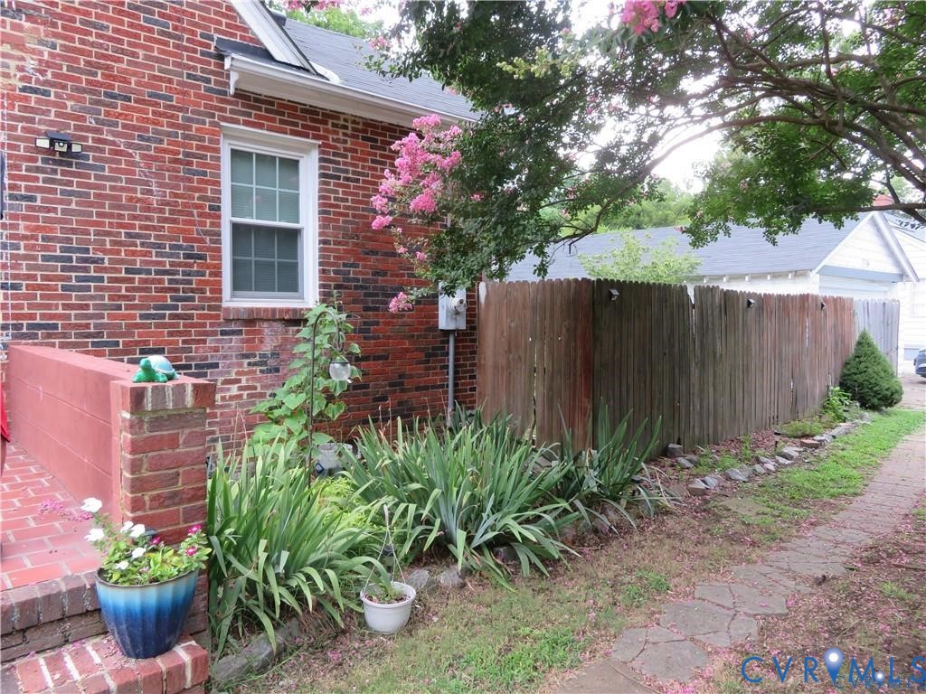 5900 River Road Petersburg, VA 23803 - Photo 13 of 44 a view of a backyard with plants and wooden fence