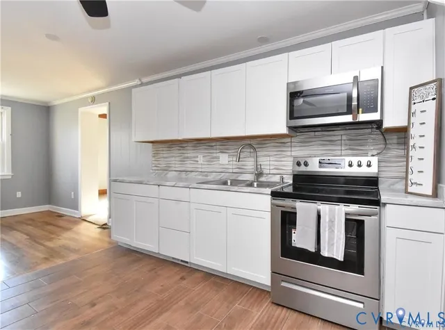 a kitchen with stainless steel appliances granite countertop a sink and a stove