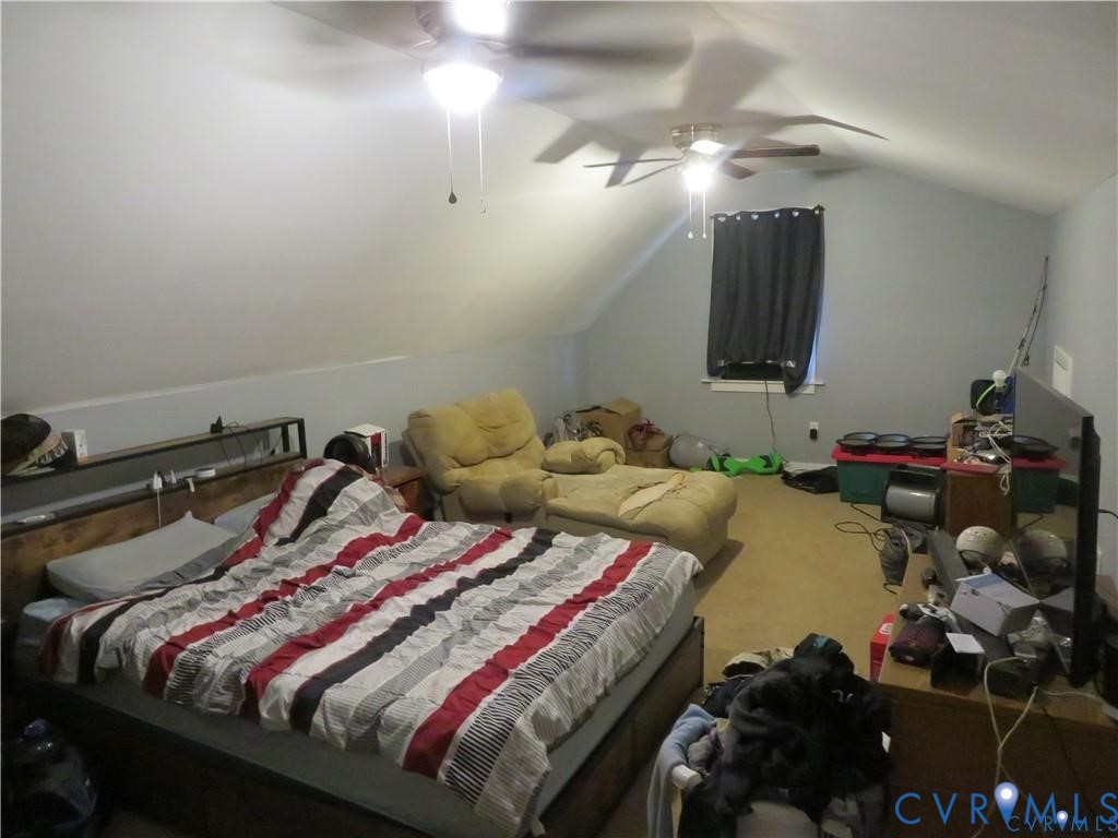 5900 River Road Petersburg, VA 23803 - Photo 42 of 44 a bed sitting in a bedroom next to a lamp