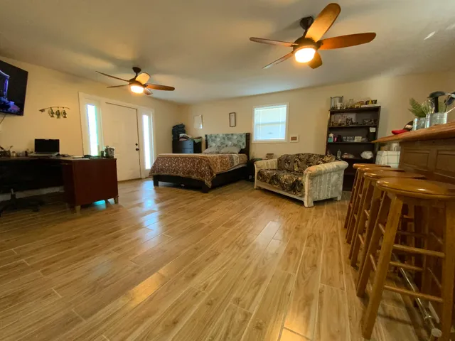 a living room with furniture and a wooden floor