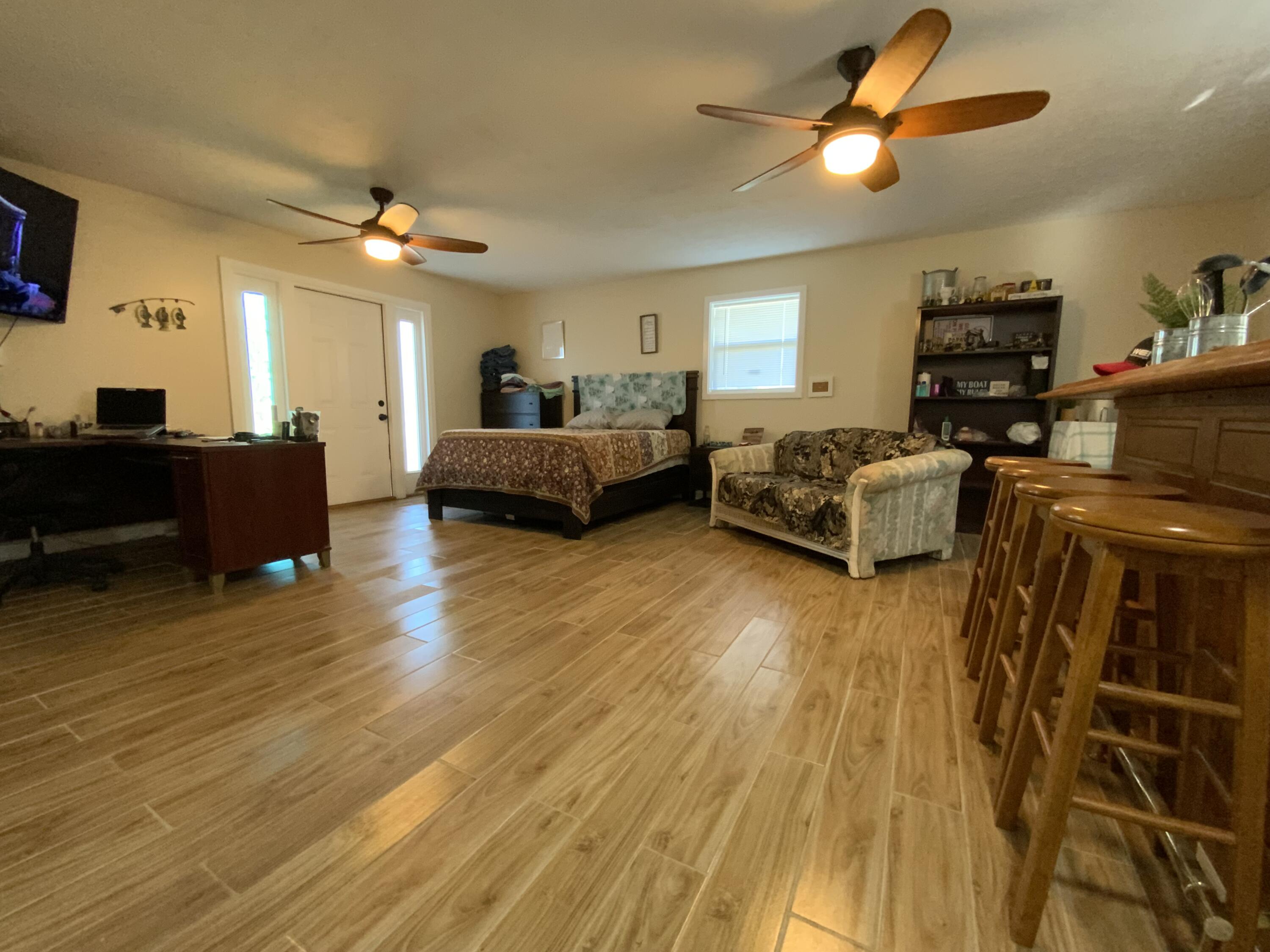 1095 Chobee Loop Okeechobee, FL 34974 - Photo 17 of 46 a living room with furniture and a wooden floor