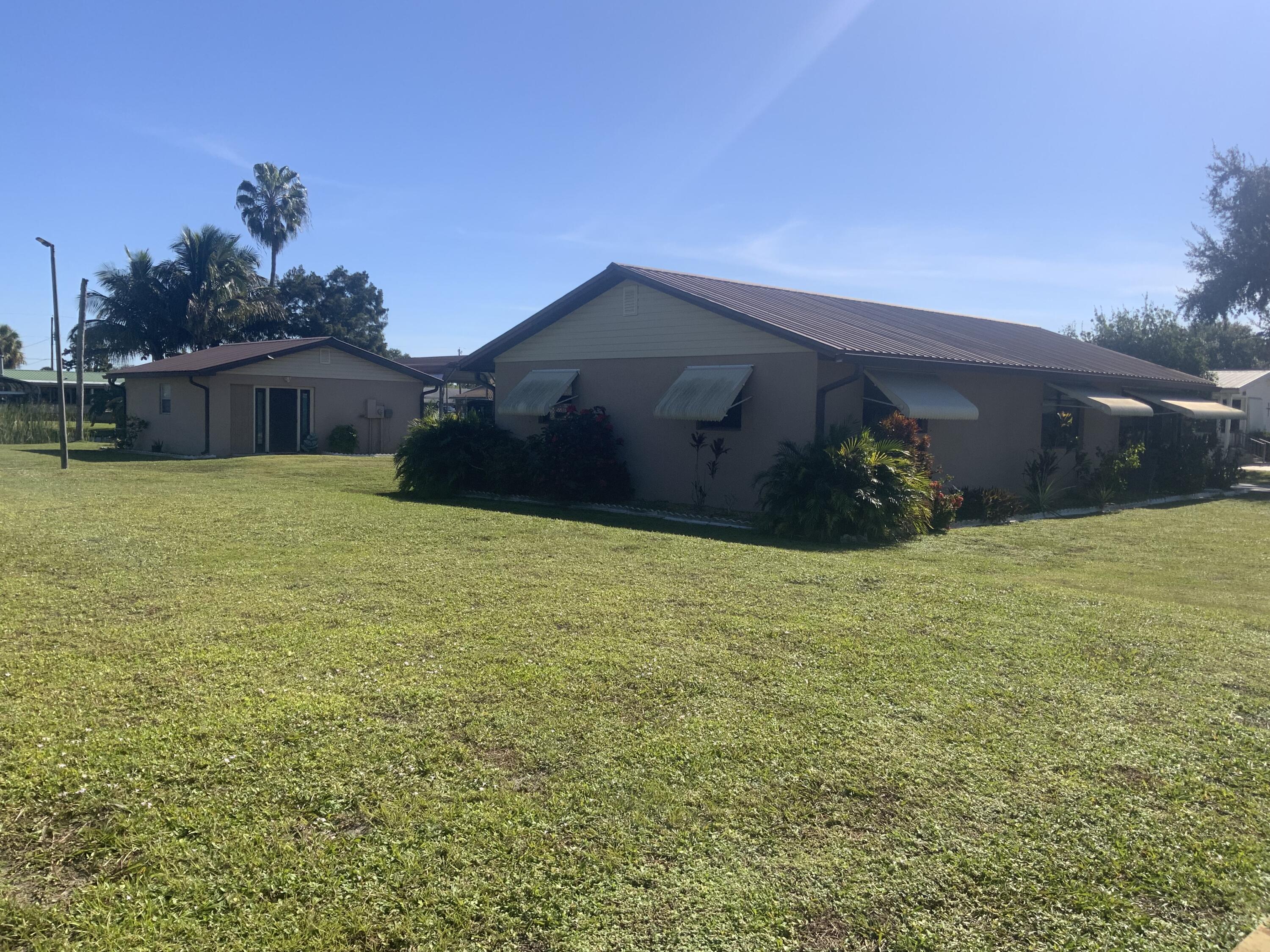 1095 Chobee Loop Okeechobee, FL 34974 - Photo 2 of 46 a house with a garden