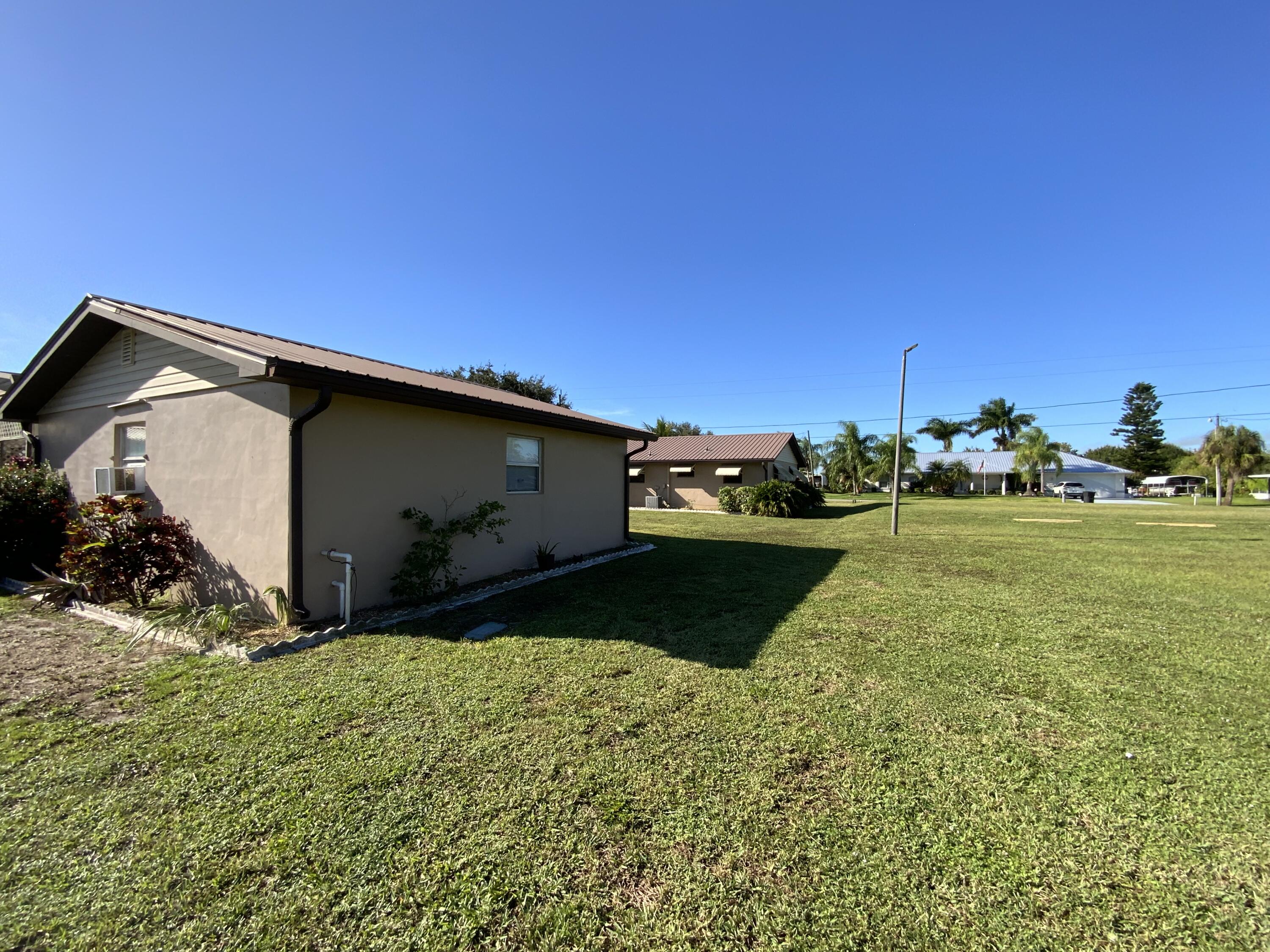 1095 Chobee Loop Okeechobee, FL 34974 - Photo 22 of 46 a view of a back yard of the house and front view of a house