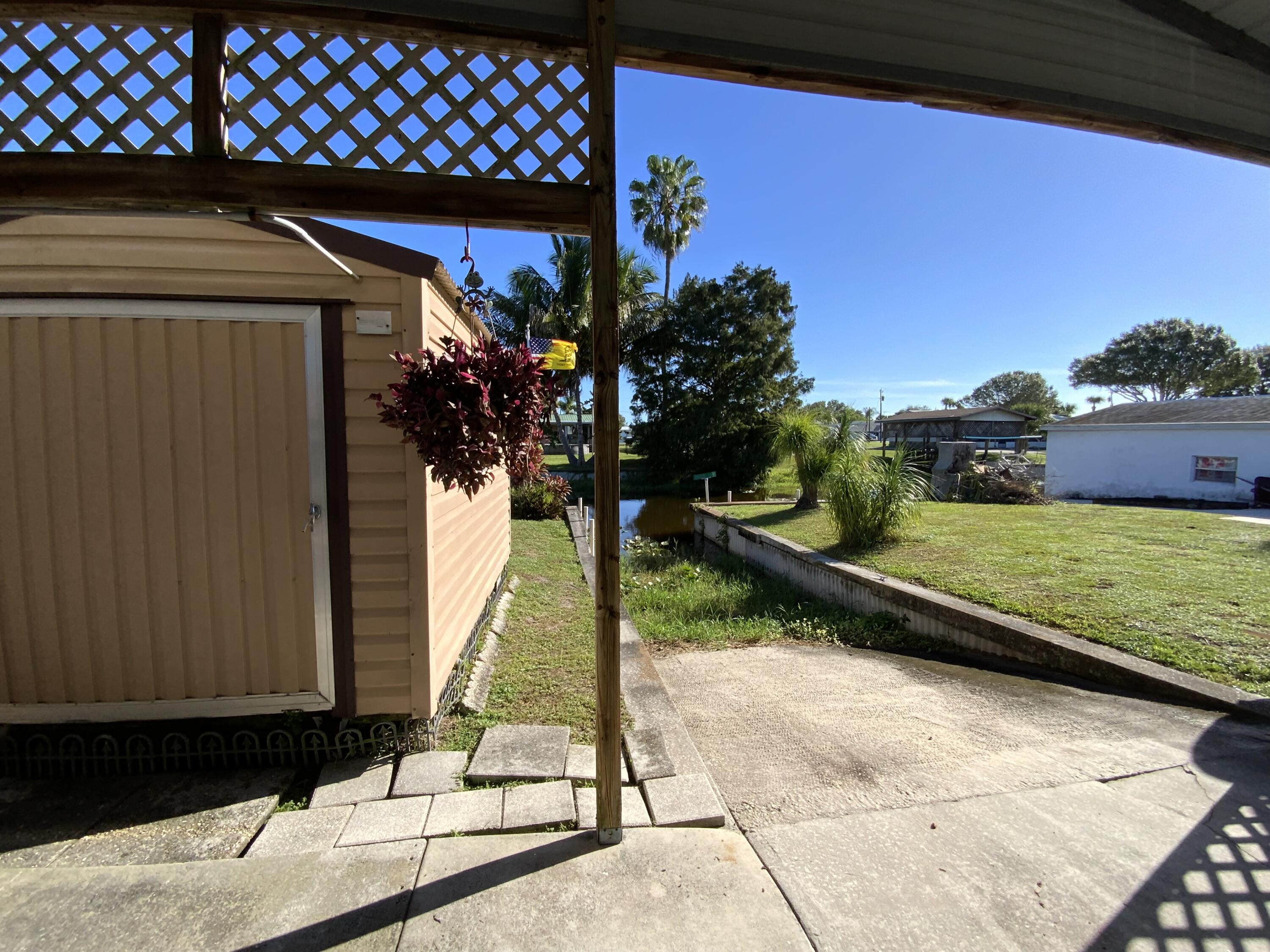 1095 Chobee Loop Okeechobee, FL 34974 - Photo 24 of 46 a view of a backyard with a chair