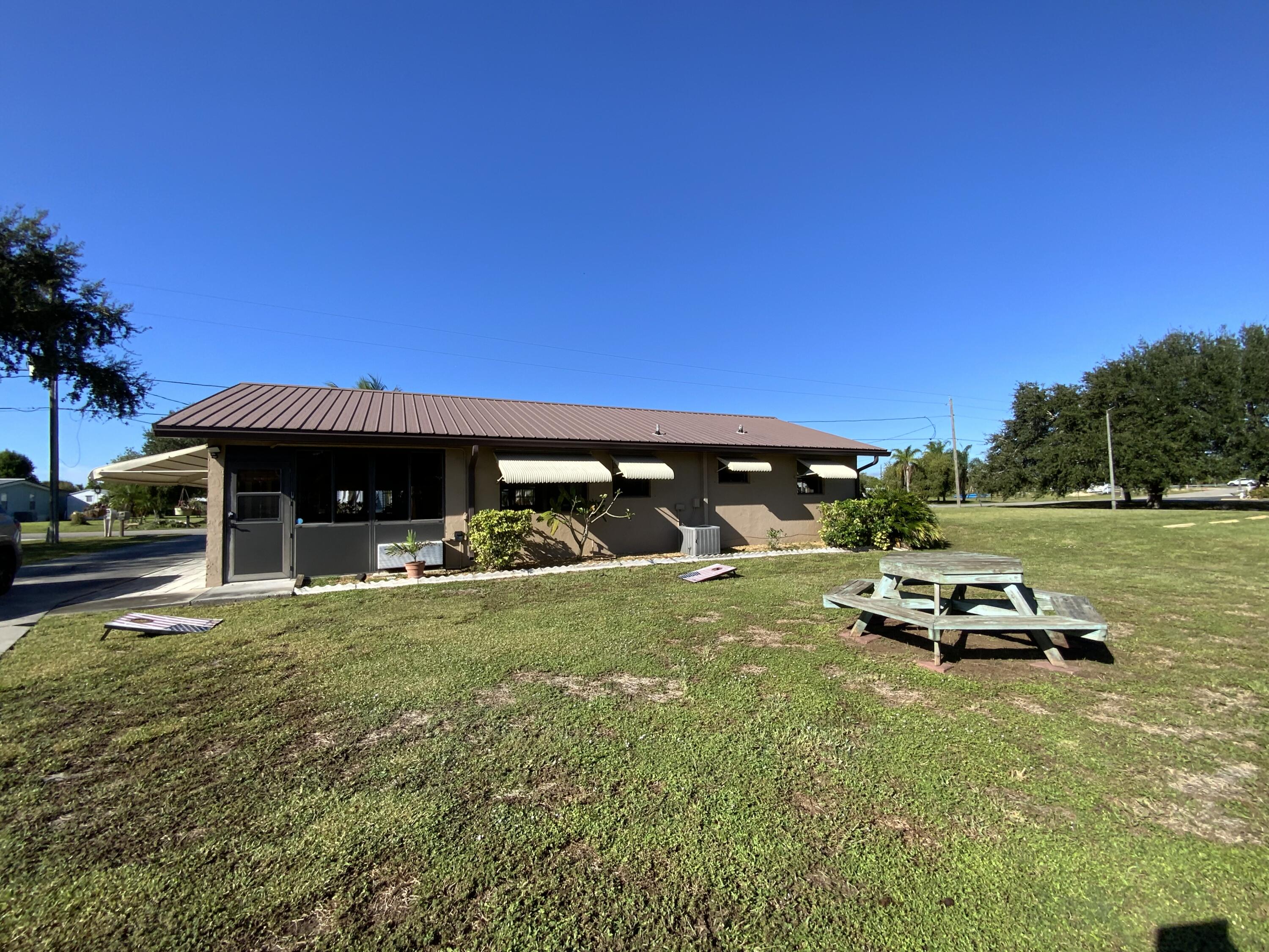 1095 Chobee Loop Okeechobee, FL 34974 - Photo 26 of 46 a view of a car parked in front of a house