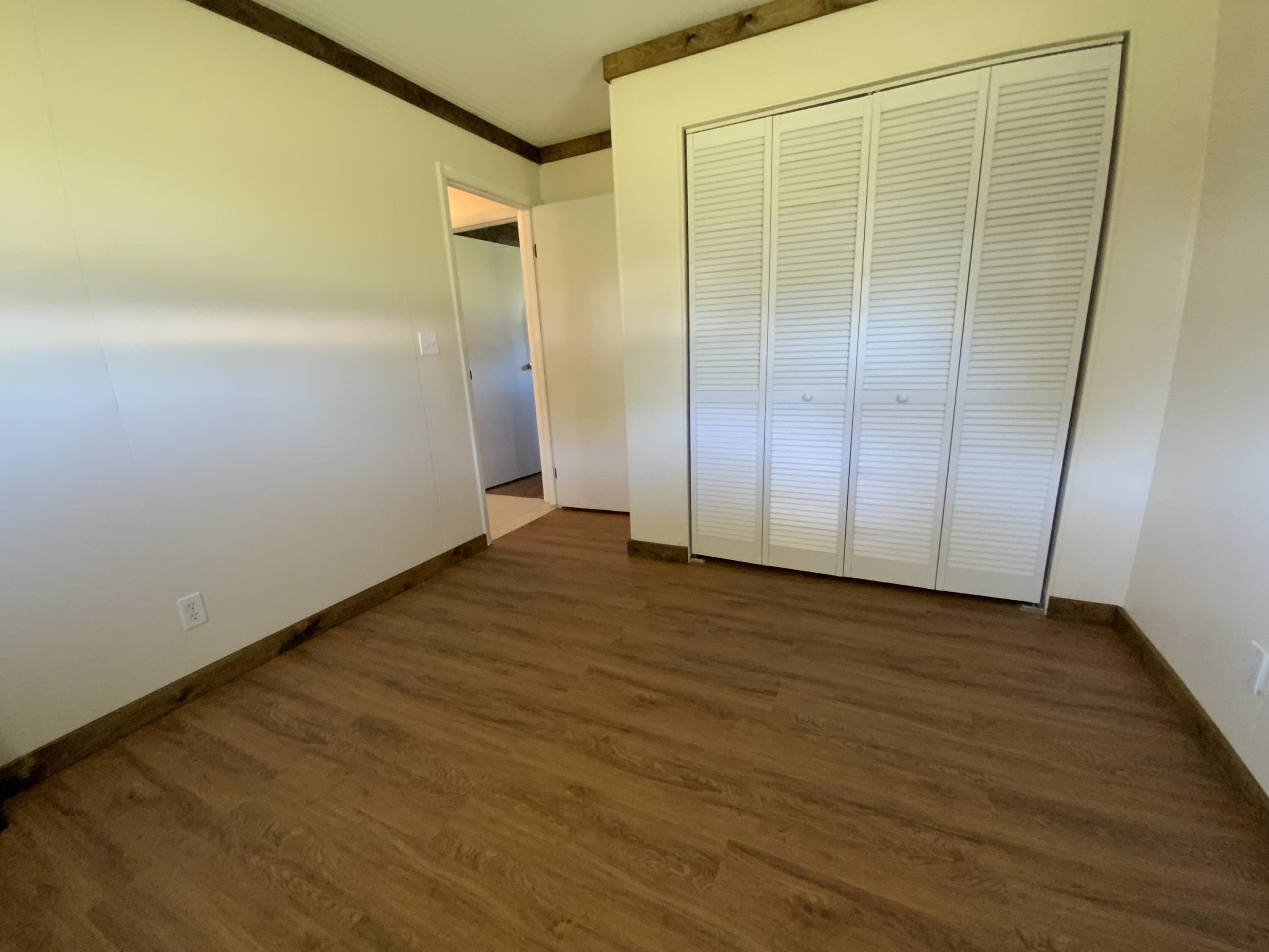 1095 Chobee Loop Okeechobee, FL 34974 - Photo 35 of 46 a view of an empty room with wooden floor