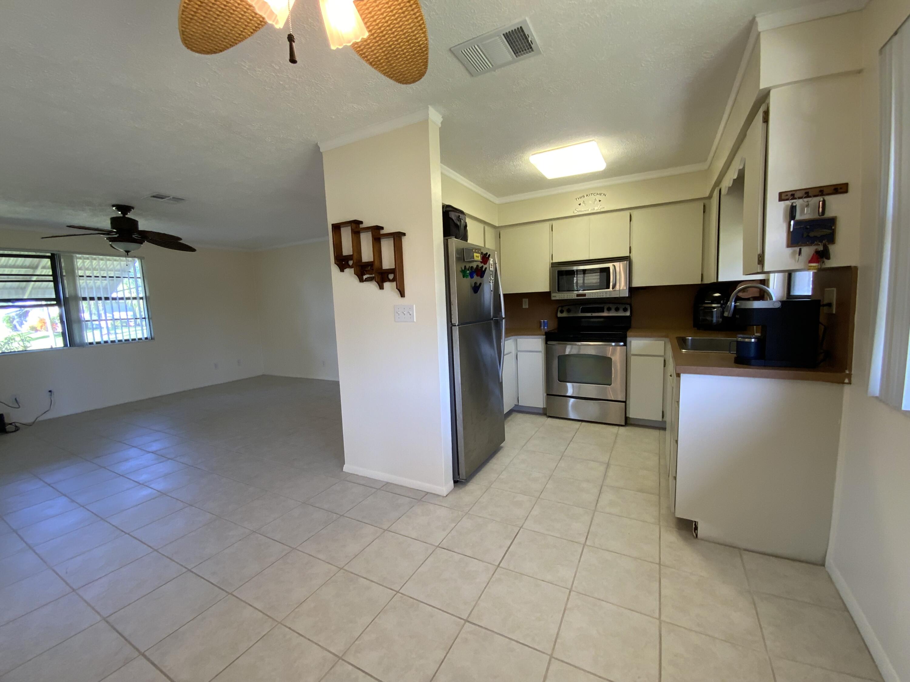 1095 Chobee Loop Okeechobee, FL 34974 - Photo 41 of 46 a open kitchen with cabinets and stainless steel appliances