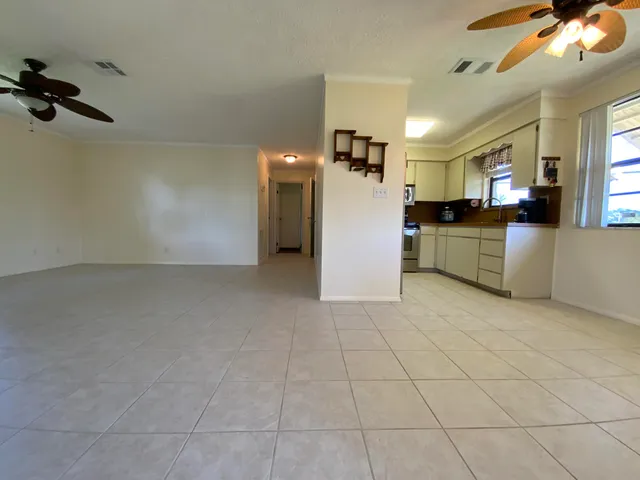 a view of a kitchen with a sink and a refrigerator